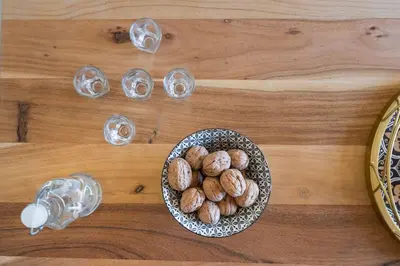 a bowl of nuts on a table with wine glasses at Villa Eleftheria in Áyios Yeóryios