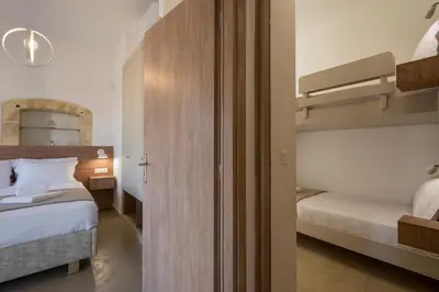 a bedroom with two beds and a bunk bed at Villa Eleftheria in Áyios Yeóryios