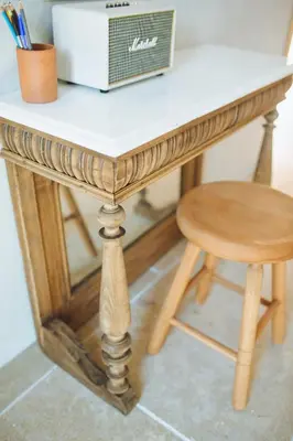 a wooden desk with a stool and a box on it at The Theodore Boutique Hotel- adults only 16 plus in Agia Marina Nea Kydonias