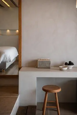 a room with a counter and a stool and a bed at The Theodore Boutique Hotel- adults only 16 plus in Agia Marina Nea Kydonias