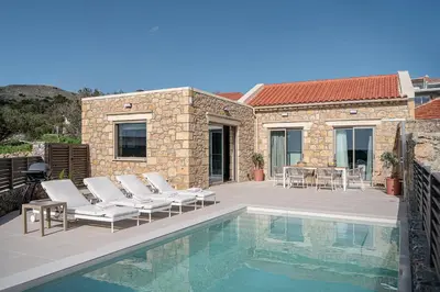 a patio with chairs and a swimming pool at Casa Nougia in Chania Town