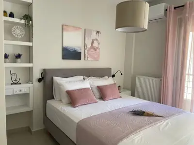 a bedroom with a bed with two pink pillows at Stefania's House in Chania Town