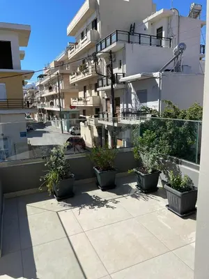 a balcony with potted plants on the side of a building at Stefania's House in Chania Town