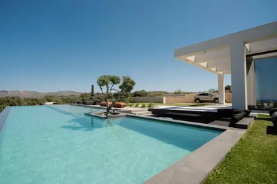 a swimming pool in the backyard of a house at Hygge Villa Evgenia in Kounoupidhianá