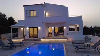 a house with a swimming pool in front of a house at Montis villa sea view heated pool in Daratso