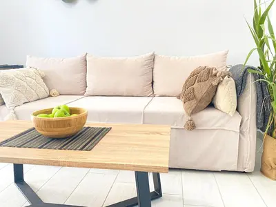 a living room with a couch and a coffee table at YVONNE's HOUSE in Chania Town