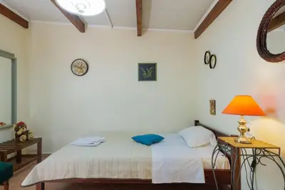 a bedroom with two beds and a lamp at Paradise Lost in Gerani Chanion