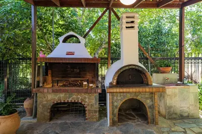 an outdoor grill with a large oven in a yard at Paradise Lost in Gerani Chanion
