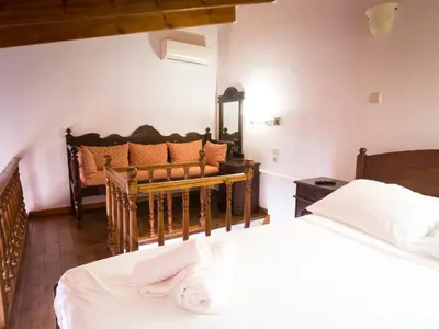 a bedroom with two beds and a couch at Xenon Apartments in Chania Town
