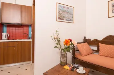 a living room with a couch and a table with flowers at Xenon Apartments in Chania Town
