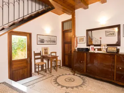 a living room with a staircase and a mirror at Xenon Apartments in Chania Town