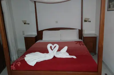 two towels in the shape of hearts are on a bed at Xenon Apartments in Chania Town