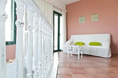 a living room with a white couch and a table at Villa Smaragdi - Private Sea View Villa in Falasarna
