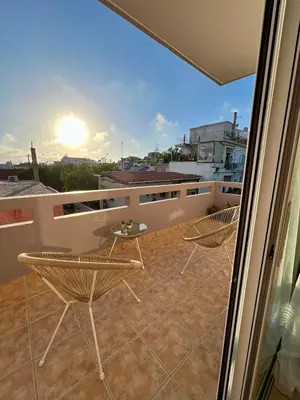 a balcony with chairs and a table on a roof at Stratos Apartment in Chania Town