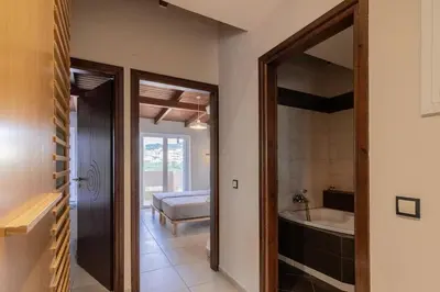a bathroom with a tub and a sink and a mirror at Alpha delight apartment 3 bedroom in Chania Town