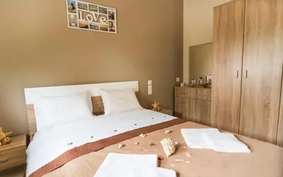 a bedroom with a large bed with towels on it at Xirouchakis farm2 in Kissamos