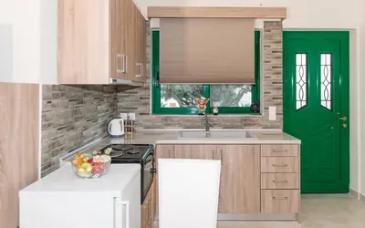 a kitchen with a green door and a sink at Xirouchakis farm2 in Kissamos