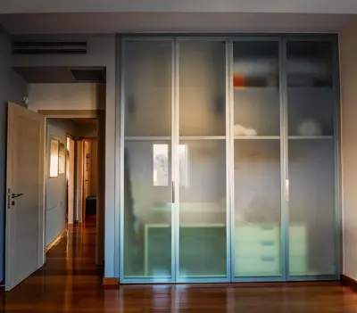 a large glass cabinet in a room with a hallway at Pentari-Bitsakis House in Chania Town