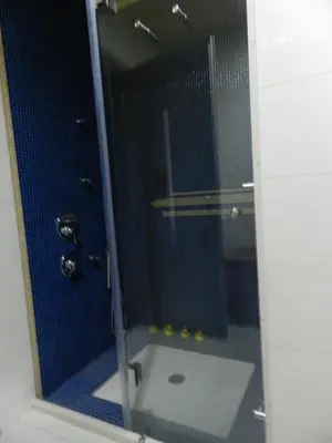 a bathroom with a shower with a glass door at Pentari-Bitsakis House in Chania Town