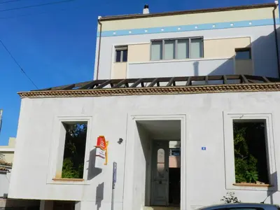 a white building with a door in front of it at Pentari-Bitsakis House in Chania Town