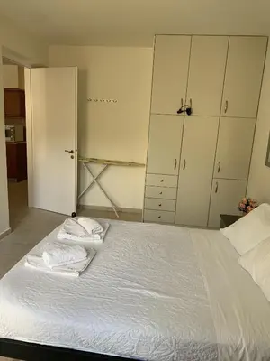 a bedroom with a bed with two towels on it at Villa Elias & Casseiopia in Chania Town