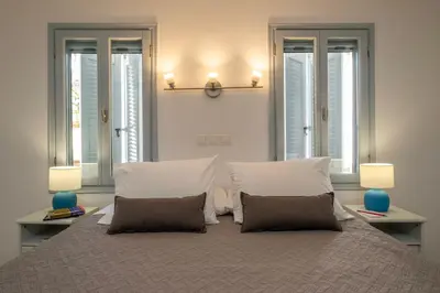 a bedroom with a large bed with two pillows at s - plazza residence in Chania Town