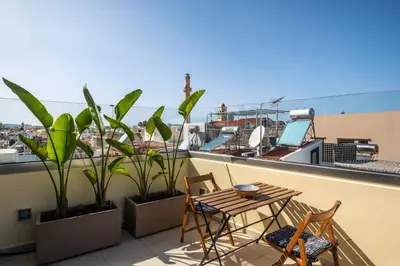 a balcony with a table and chairs and plants at s - plazza residence in Chania Town