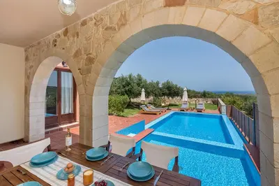 an external view of a villa with a swimming pool at Villa Katerina with Eco heated pool in Spiliá