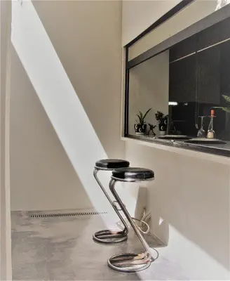 a stool sitting in a room with a mirror at SQUARE 45 in Chania Town