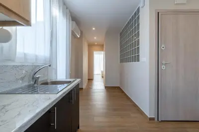 a kitchen with a sink and a door to a hallway at Odyssey Residences in Chania Town