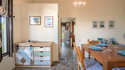a dining room with a wooden table and a dining room at Yiannis Cottage in Spiliá