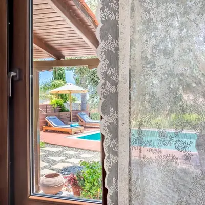 a window with a view of a pool at Yiannis Cottage in Spiliá