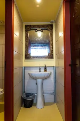 a bathroom with a sink and a mirror at Chania Hostel Youth 18-50 in Chania Town