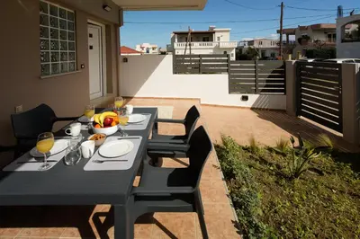 a table with a bowl of fruit on a patio at Kiss-ammos Apartments in Kissamos