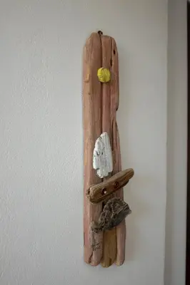 a wooden wall decoration on a white wall at Mamouth Studios in Chania Town