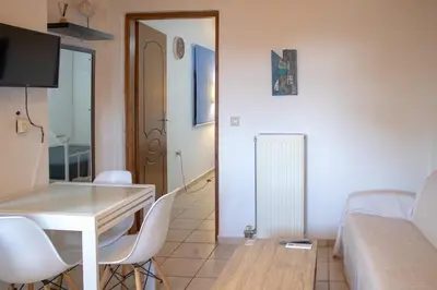 a small living room with a table and chairs at Mamouth Studios in Chania Town