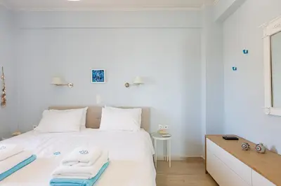 a bedroom with a white bed with towels on it at Villa Chryssi in Tersanas