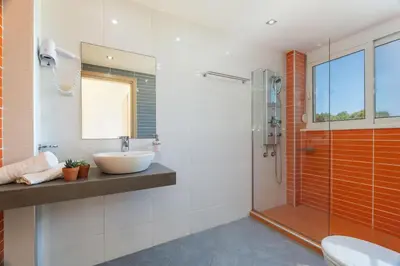 a bathroom with a sink and a shower at Villa Ariella With Sea View in Agia Marina Nea Kydonias