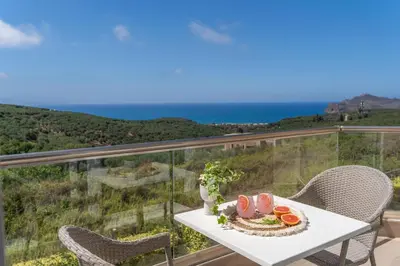 a table with a plate of fruit on a balcony at Villa Ariella With Sea View in Agia Marina Nea Kydonias