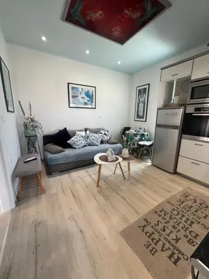 a living room with a couch and a kitchen at Nelly's Private Resindence in Chania Town