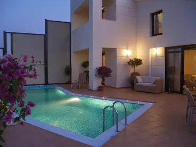 a swimming pool in front of a house at Villa Bellissima in Chania Town