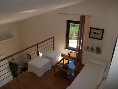 a living room with two beds and a window at Villa Bellissima in Chania Town