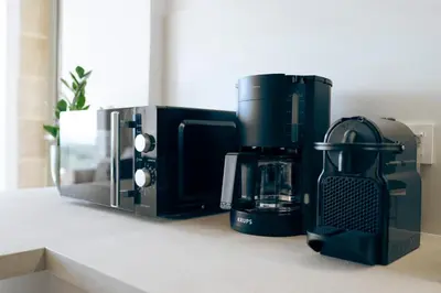 a black coffee maker sitting on a counter at Anadia Luxury Pocket Villa Infinite Sea View in Falasarna