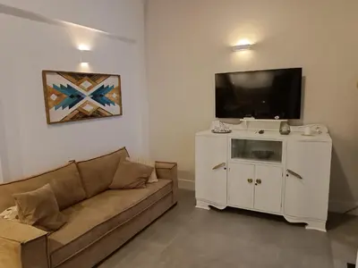 a living room with a couch and a flat screen tv at Boschini Loft Life in Chania Town