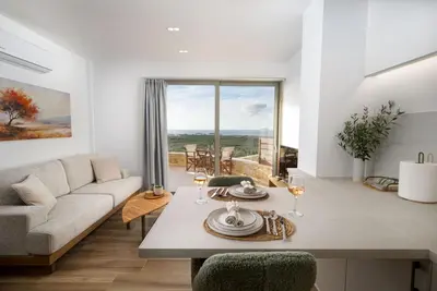 a living room with a couch and a table at Athali Luxury Pocket Villa Stunning Sea View in Falasarna