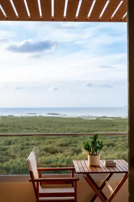 a table and chairs on a balcony with a view of the ocean at Athali Luxury Pocket Villa Stunning Sea View in Falasarna