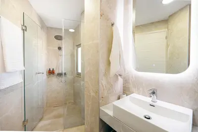 a bathroom with a sink and a shower at Athali Luxury Pocket Villa Stunning Sea View in Falasarna