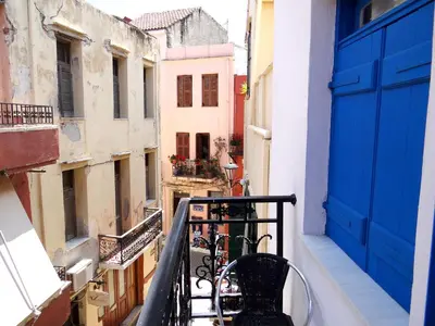 a view of an alley from a balcony with a blue door at Villa Archondisa in Chania Town
