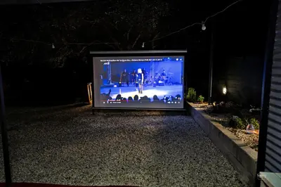 a large television sitting on a gravel road at night at Lemon Garden Camper in Chania Town