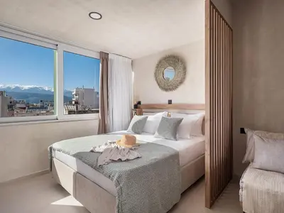 a bedroom with a bed and a large window at Aura Urban Living in the heart of Chania city in Chania Town